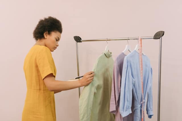 woman looking at clothing on rack